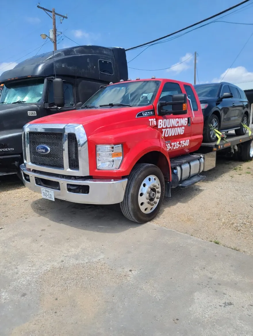 Bouncing Towing red Ford tow truck at Dallas fleet yard